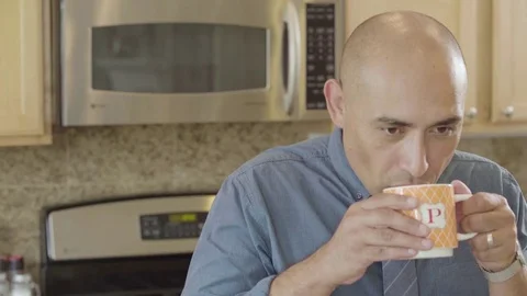 Man having a cup of coffee in the kitchen 스톡 동영상 83186340