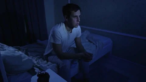 Man having depression sitting on the bed 動画素材 165345603