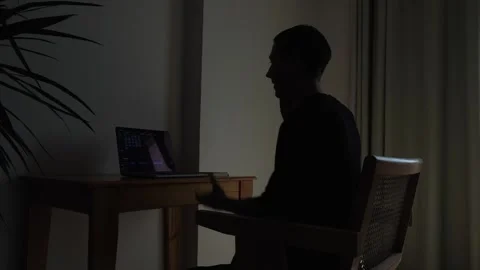 Man having a difficult work conversation by phone while gesturing toward laptop Stock Footage 346245451