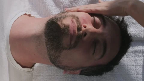 Man having face massage, face yoga for antiaging benefits Stock Footage 333069244