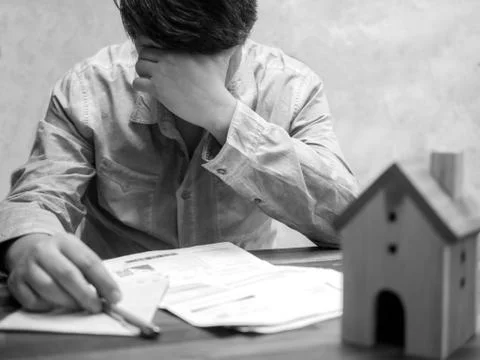 Man having financial problems with home debt and invoices, Money concept., re Stock Photos