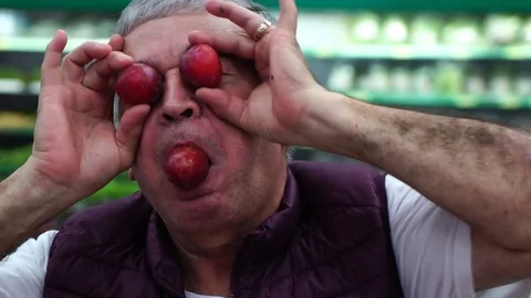 Man Having Fun with Plums Video stock 85066985