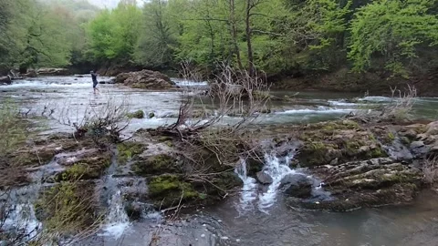 Man having fun in the river Stock Footage 326895475