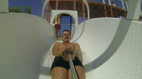 Man having fun, sliding at water park Stock Footage 64149000