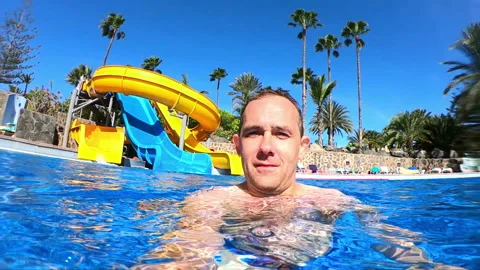 Man having fun in swimming pool in slow motion 250fps Video stock 119576315