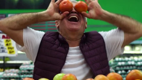 Man Having Fun with Tomatoes Stock Footage 85066898