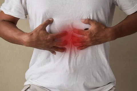 Man having gastric problems on gray background Stock Photos
