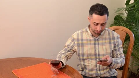 Man Having a Glass of Wine While Texting Stock Footage 49810836
