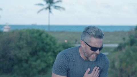 Man having heart attack during sport run outdoor. Heart attack while running and Stock Footage 345972811
