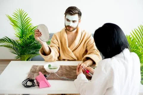 Man is having his nails done Stock Photos