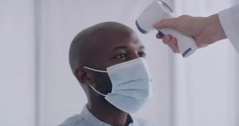 Man having his temperature checked while... | Stock Video | Pond5