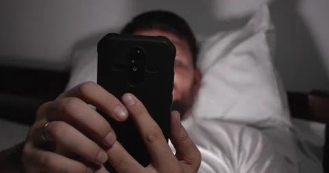 Man having an insomnia and looking at  cellphone Video stock 166728538