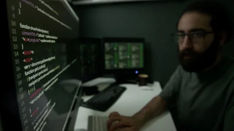 Man Having Intense Coding Session in Dimly Lit Programmer Workspace Video stock 302195308