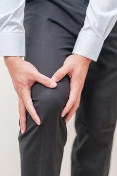 Man having knee ache and muscle pain due to Runners Knee or Patellofemoral .. Stock Photos