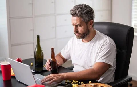 Man having morning hangover. Tired employee work in home office after party Stock Photos