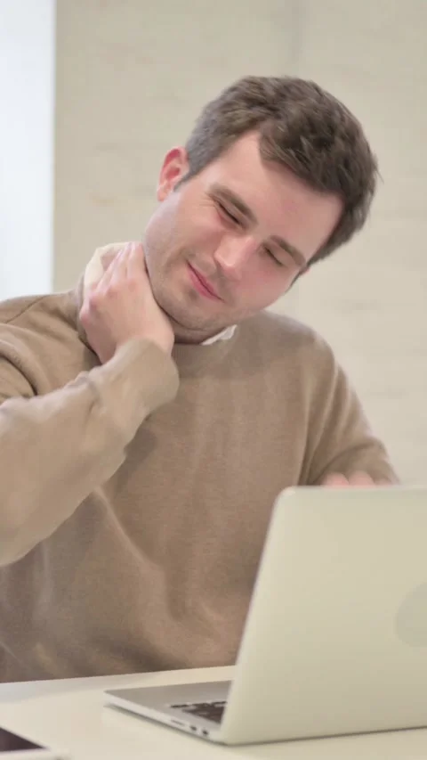 Man having Neck Pain while using Laptop in Office, Vertical Video Stock Footage 337351142