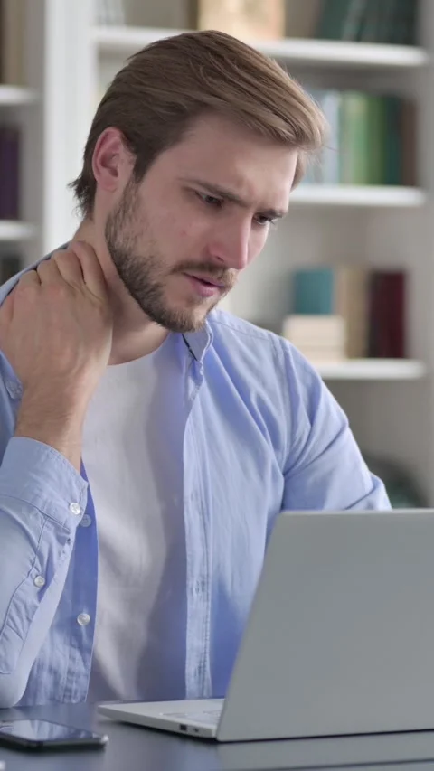 Man having Neck Pain while Typing on Laptop, Vertical Video Stock Footage 339577899