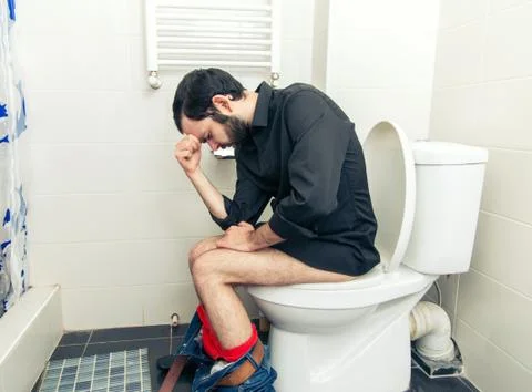 Man having problems in the toilet Stock Photos