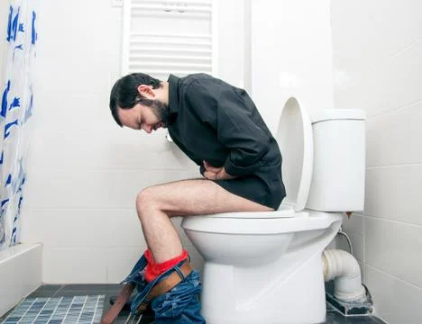 Man having problems in the toilet Stock Photos