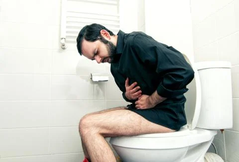 Man having problems in the toilet Stock Photos