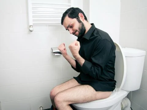 Man having problems in the toilet Stock-Fotos