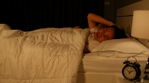 Man having sleepless on bed and having migraine,stress, in the bedroom at night Stock Footage 86437926