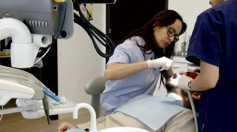 Man having teeth whitening operation at dental studio Stock Footage 46002544