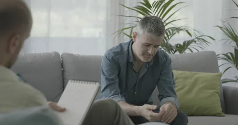 Man having a therapy session with a professional psychologist Stock Footage 162354043