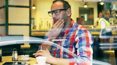 Man having toothache in the restaurant, steadycam shot Stock Footage 44209782