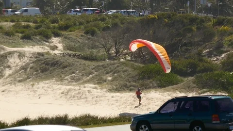 Man having trouble with parasail Stockbeeldmateriaal 104405010