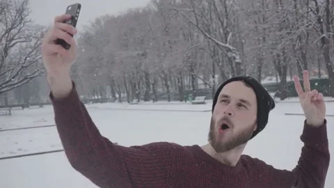 Man having video chat using smartphone outdoors sharing travel adventure. Selfie Stock Footage 85592308