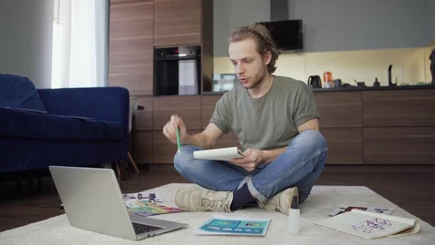 Man having video conference with colleagues at home Stock Footage 128572353