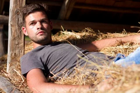 Man on hay Stock Photos