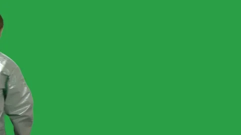 Man in hazmat looks around with flash light and finds hard drive. Green Screen. Stock Footage 99608902