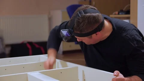 Man With Head Camera Assembling Furniture Stock Footage 167218989