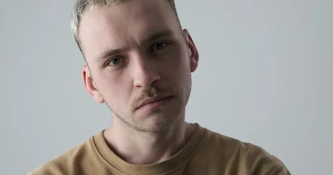 Man with head cocked on studio background Stock Footage 105176739