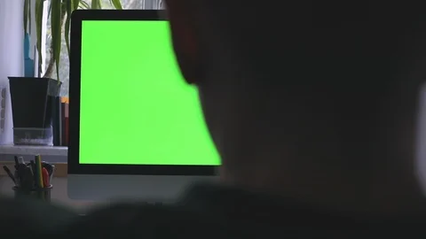 Man head on personal computer with green screen and chroma key work at home Stock Footage 116334877