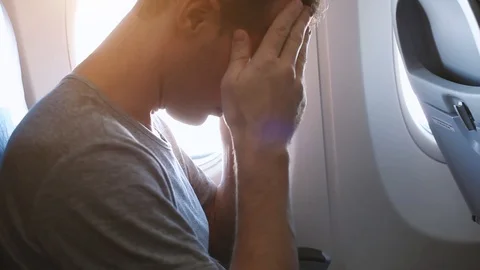 Man with headache in airplane feeling bad Stock Footage 89935901
