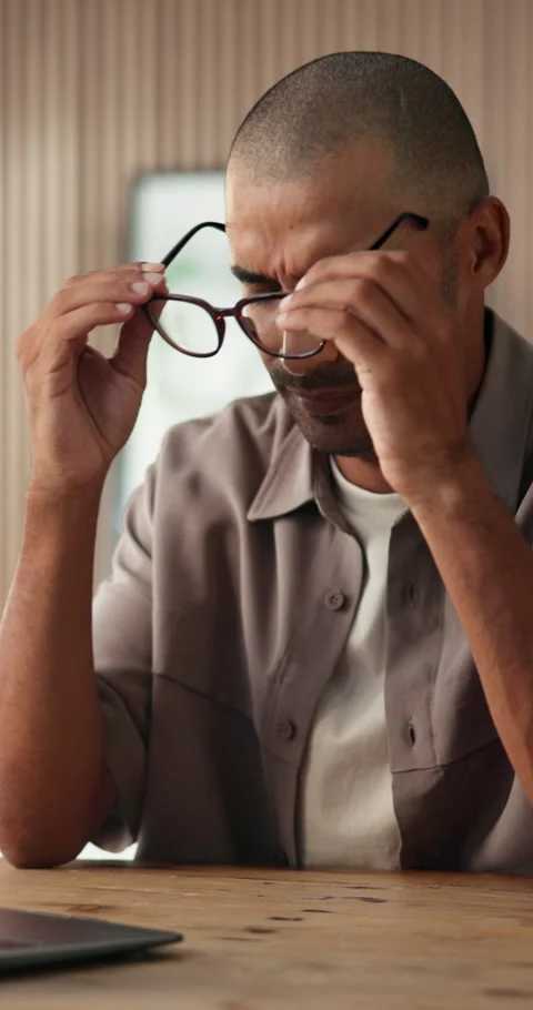 Man, headache and laptop in office with glasses, typing or software development Stock Footage 334308997