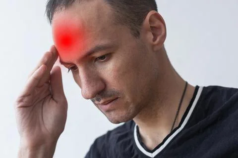 Man with headache, head hurts, experiencing pain Stock Photos