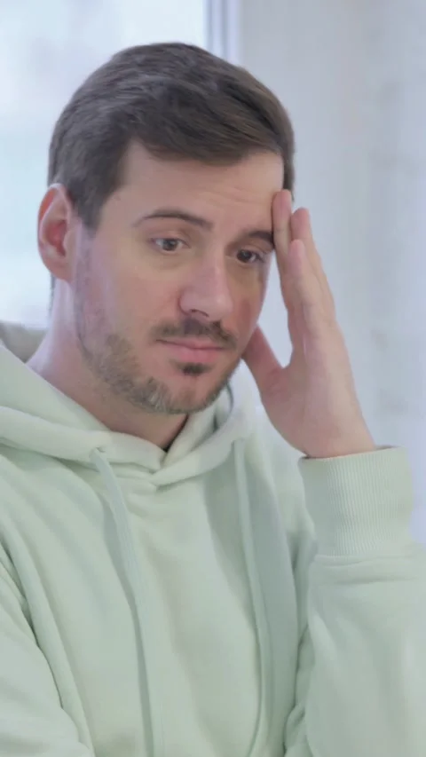 Man with Headache, Migraine while Standing Near Window, vertical video Vídeos de archivo 329105139