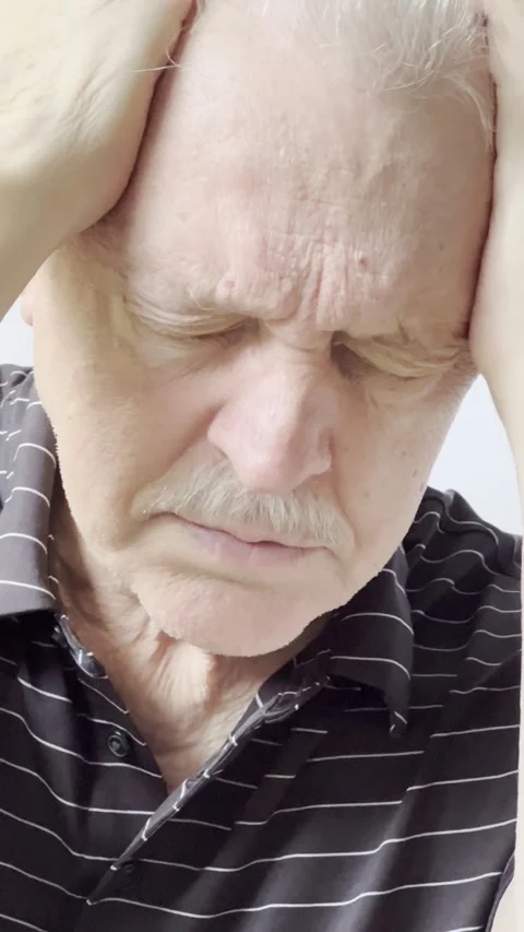 Man with headache rubs temples vertical Stock Footage 219269407