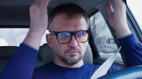 Man with headache tries to get himself in order to start driving passenger car 스톡 동영상 124306878