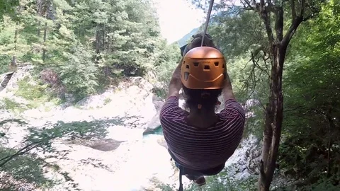 Man heading through river canyon on zipline in Slovenia. Stock Footage 97062119