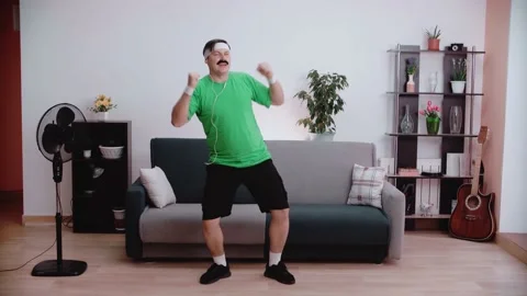 A man with headphones dances and does aerobics. Stock Footage 146265300