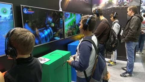 Man in headphones playing video computer game on IGROMIR (Games World) and Comic Stock Footage 81002944