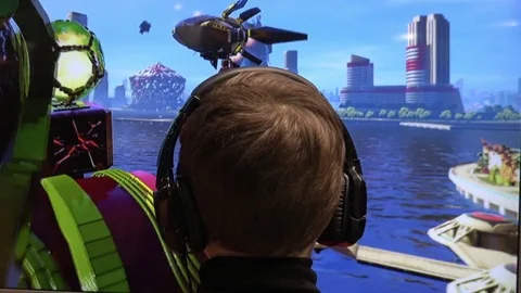 Man in headphones playing video computer game on IGROMIR (Games World) and Comic Stock Footage 81513036