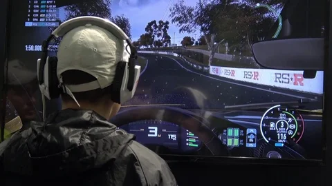 Man in headphones playing video computer game on IGROMIR (Games World) and Comic Stock Footage 83220878