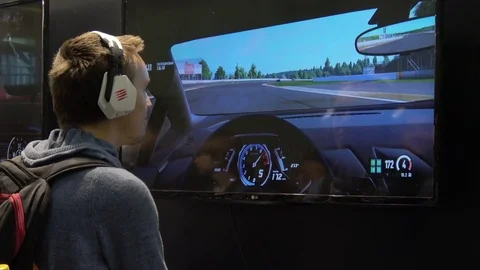 Man in headphones playing video computer game on IGROMIR (Games World) and Comic Stock Footage 83220915