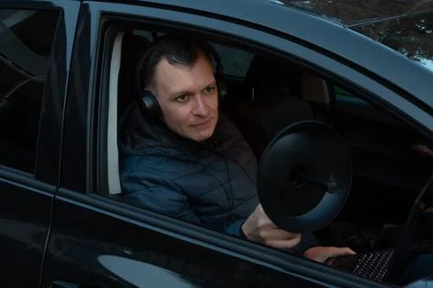 A man with headphones records conversations using a directional microphone,.. Stock-Fotos
